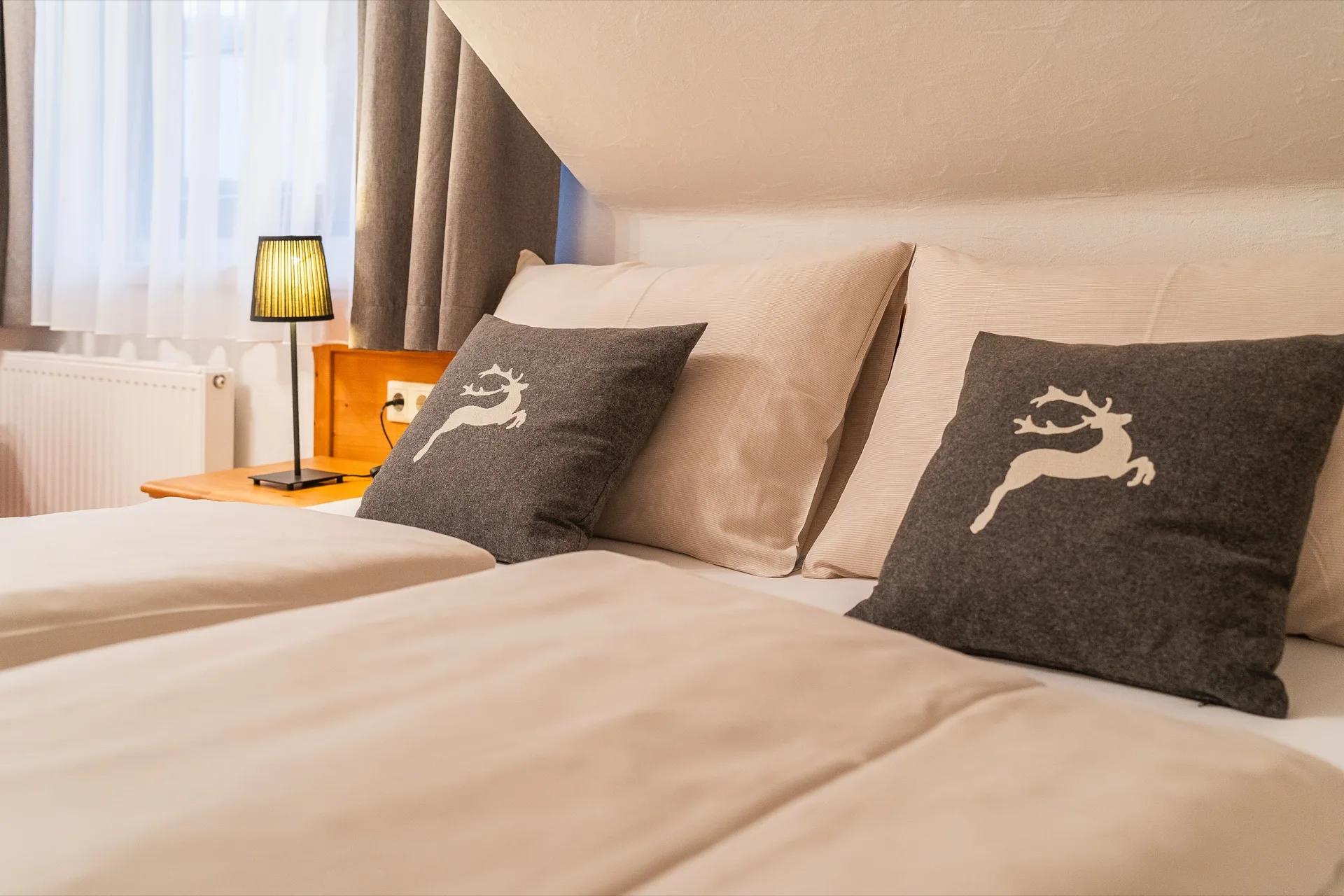 Landhaus Prägant Nr.18 — Schlafzimmer Hirsch-Kissen – Appartement Nr.18 Landhaus Prägant Bad Kleinkirchheim, professionelle Ferienwohnung Fotografie Kärnten